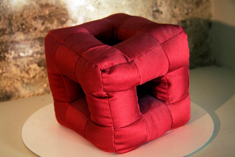The Cubic Pillow has holes - so you can lie down and watch TV, and still be able to listen to the audio properly.