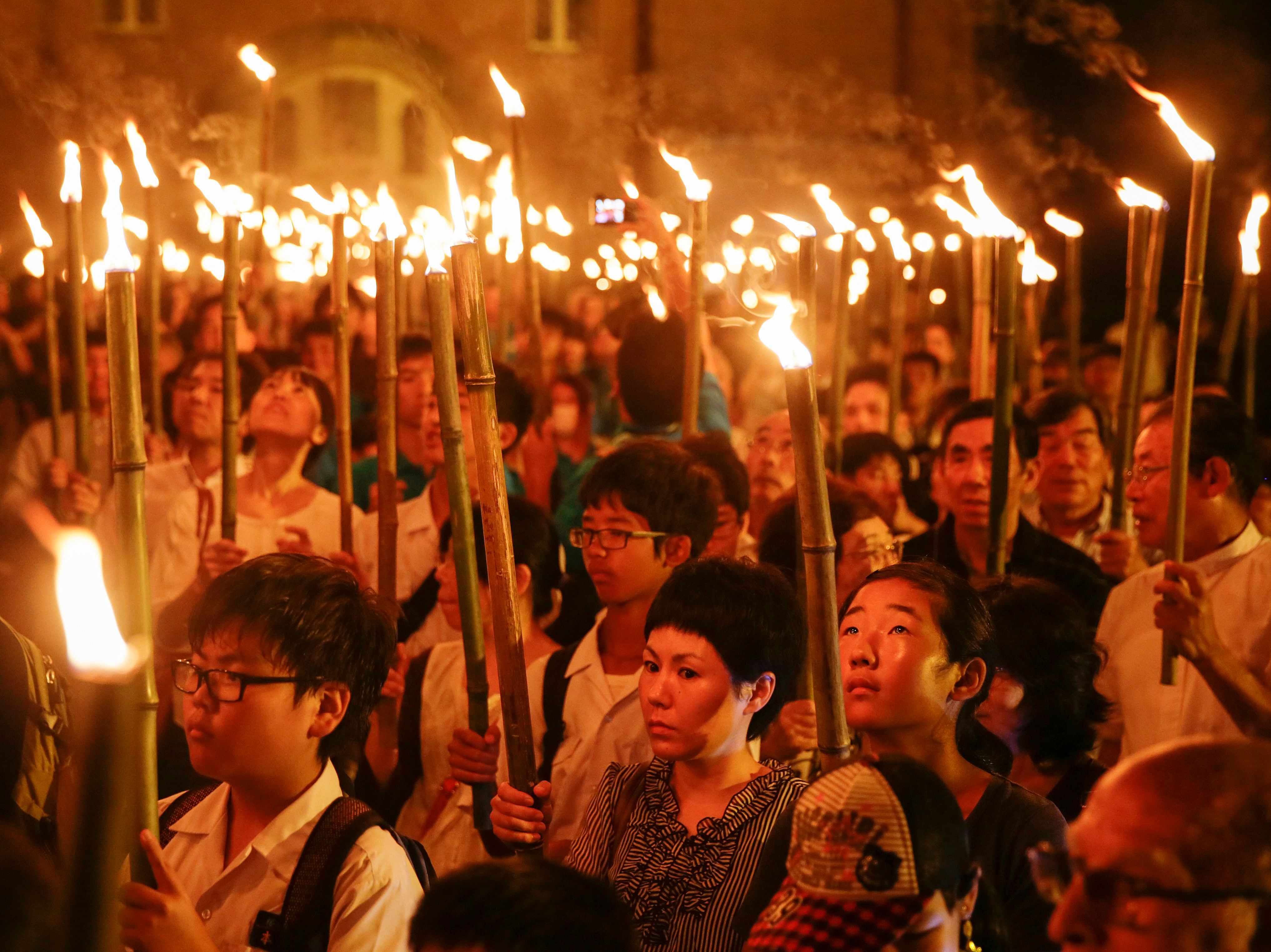 Catholics taking part in a torchlight procession from Urakami Cathedral to the Nagasaki Peace Park in south-western Japan on Sunday to remember the victims of the atomic bombing of Nagasaki on Aug 9, 1945.