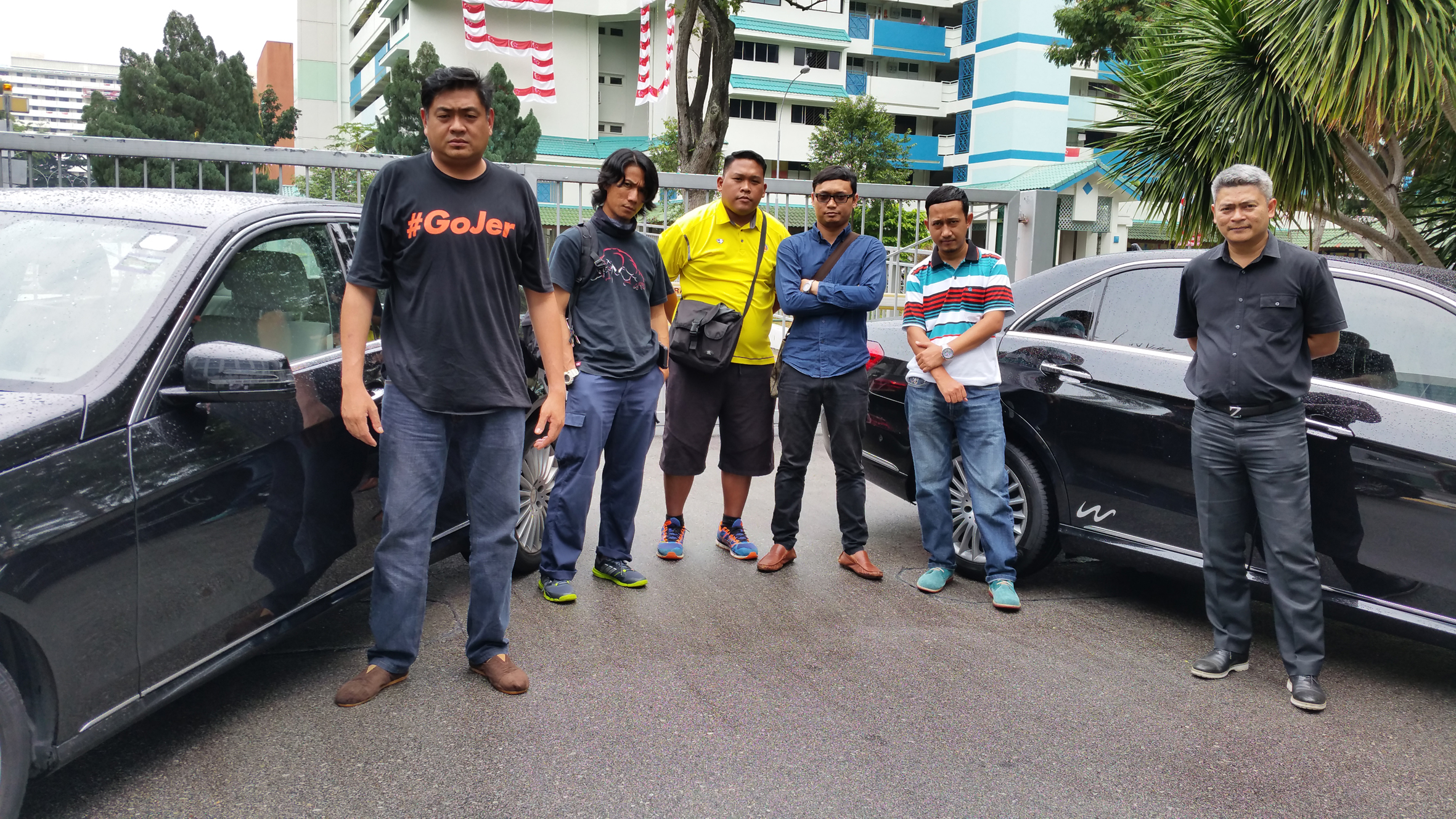 Disgruntled drivers of limousine company Wolero posing beside two of the company's Mercedes cars. They say they are acting on advice from the Land Transport Authority that "individual parties are not allowed to lease/rent private hire cars from car r