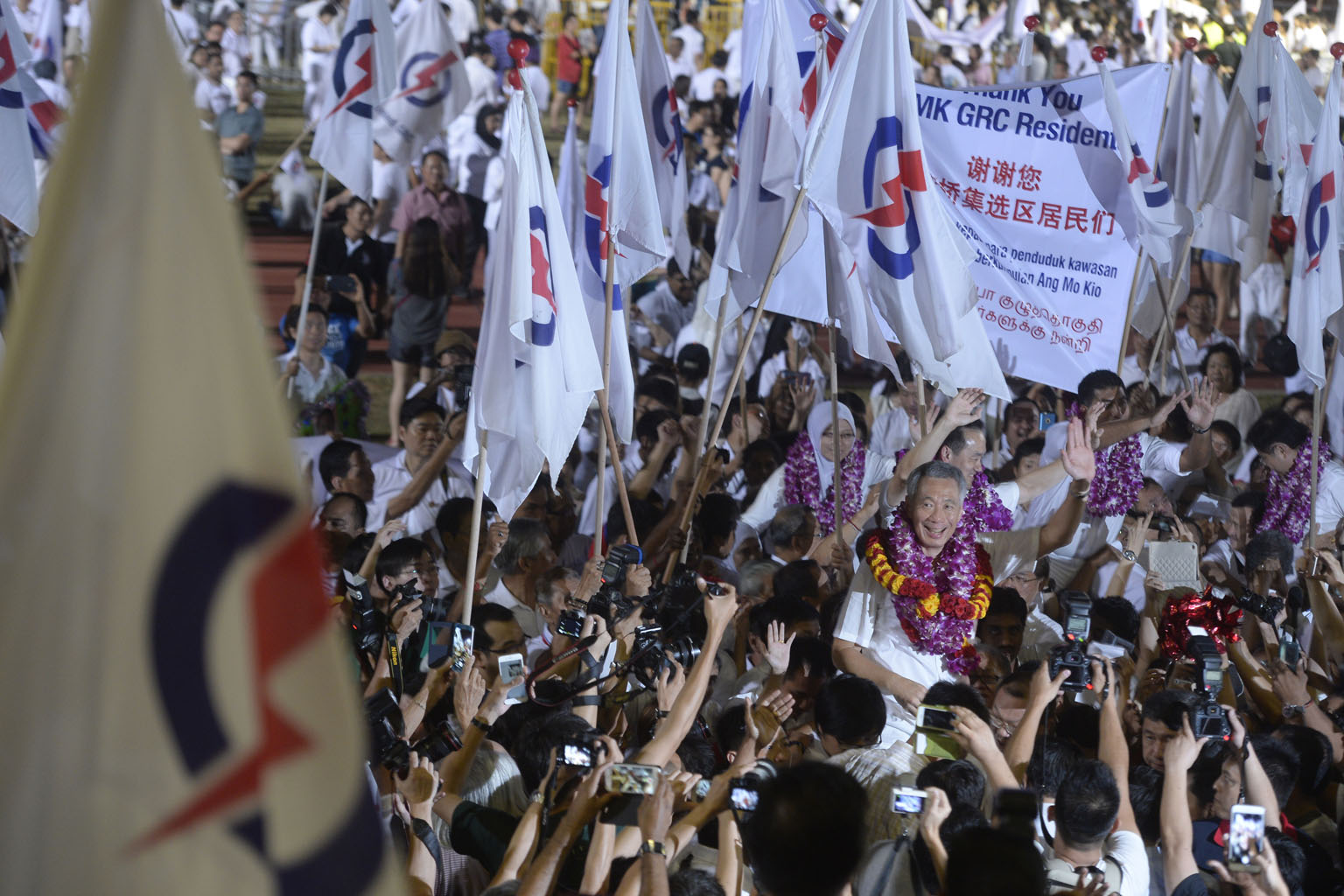 PM Lee Hsien Loong and his Ang Mo Kio GRC team celebrating their win with PAP supporters at Toa Payoh Stadium. Mr Lee thanked voters and said the results show Singaporeans know what is at stake, and are also an endorsement of the policies and the per