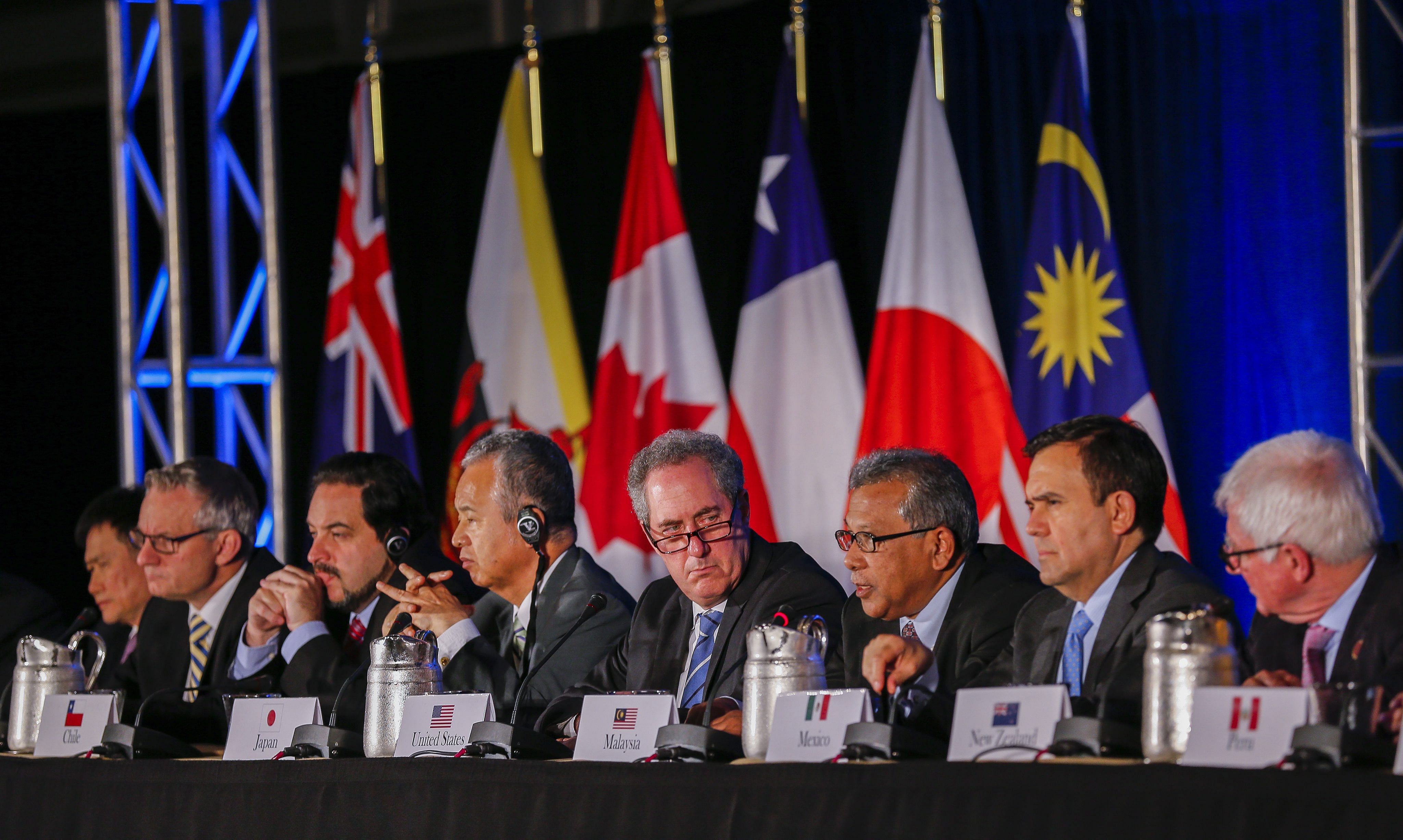 United States Trade Representative Michael Froman (centre) being flanked by international counterparts during the closing press conference after an agreement was reached by 12 TPP member countries in Atlanta, in the US, on Oct 5.