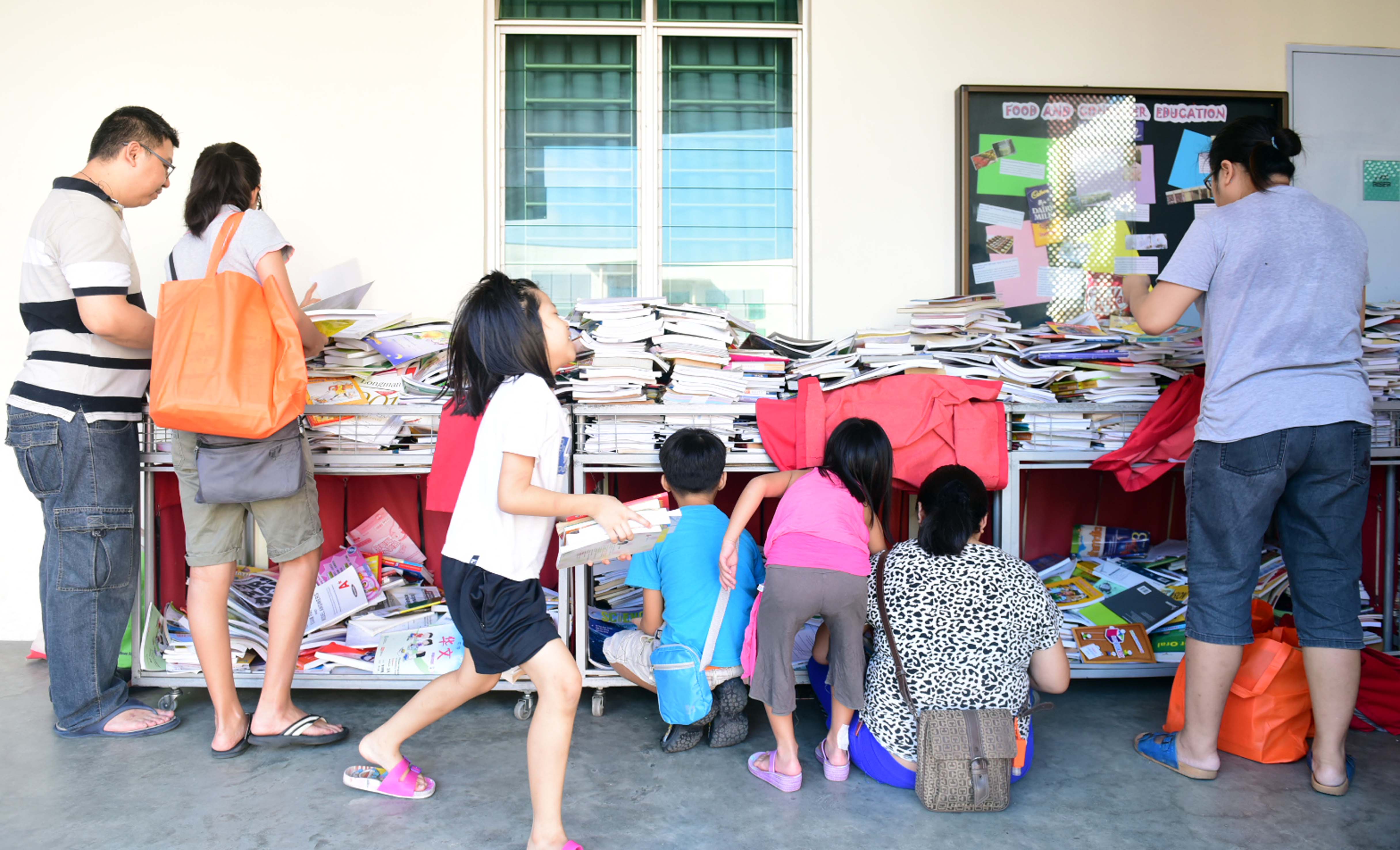 Free textbooks being distributed under the Share-A-Textbook Project by NTUC FairPrice at Gan Eng Seng School on Saturday.
