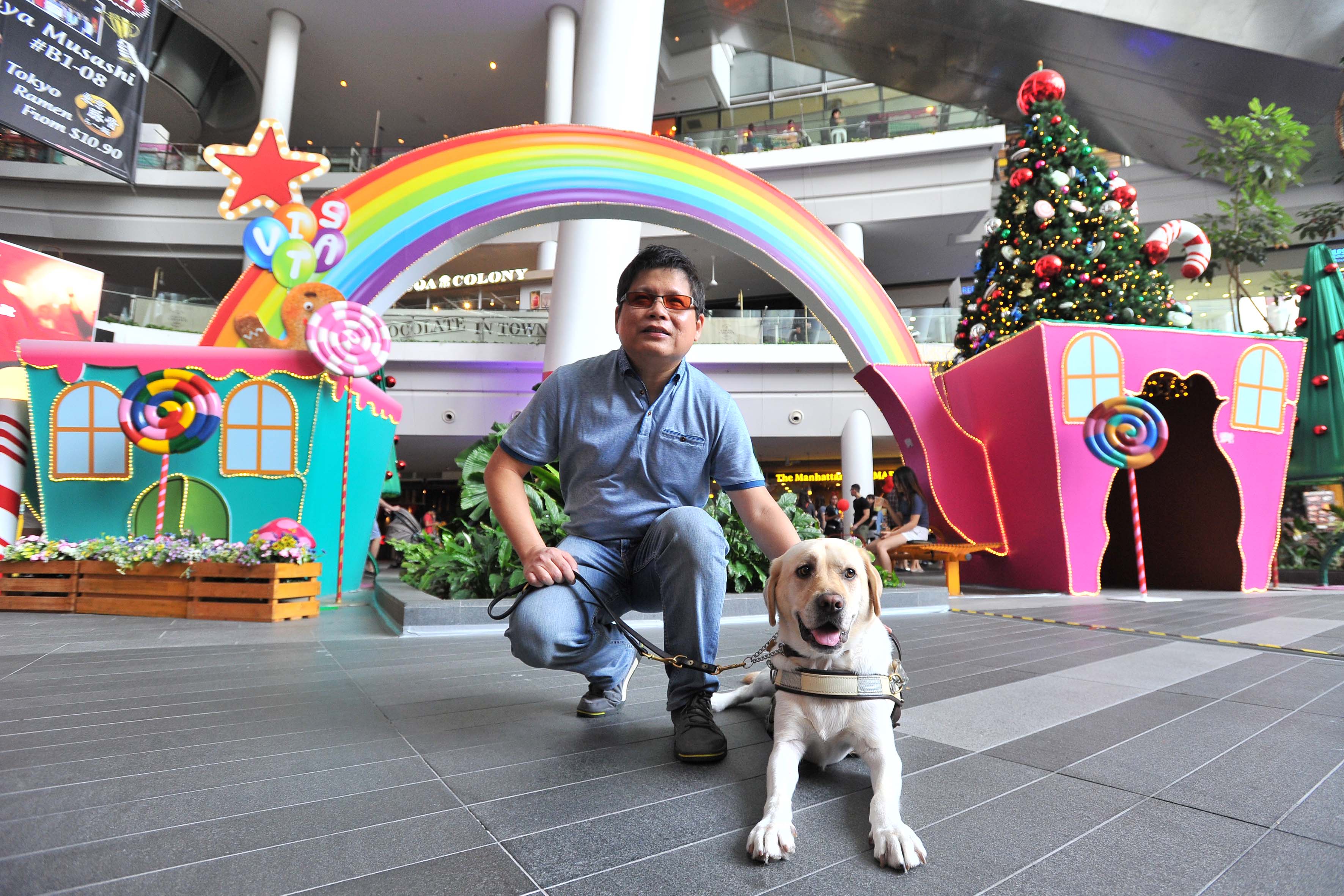 Financial services manager Dennis Sim with his guide dog Melba at The Star Vista, a guide dog-friendly mall. There has been a 50 per cent increase in the number of such places despite there being only seven guide dog users in Singapore.