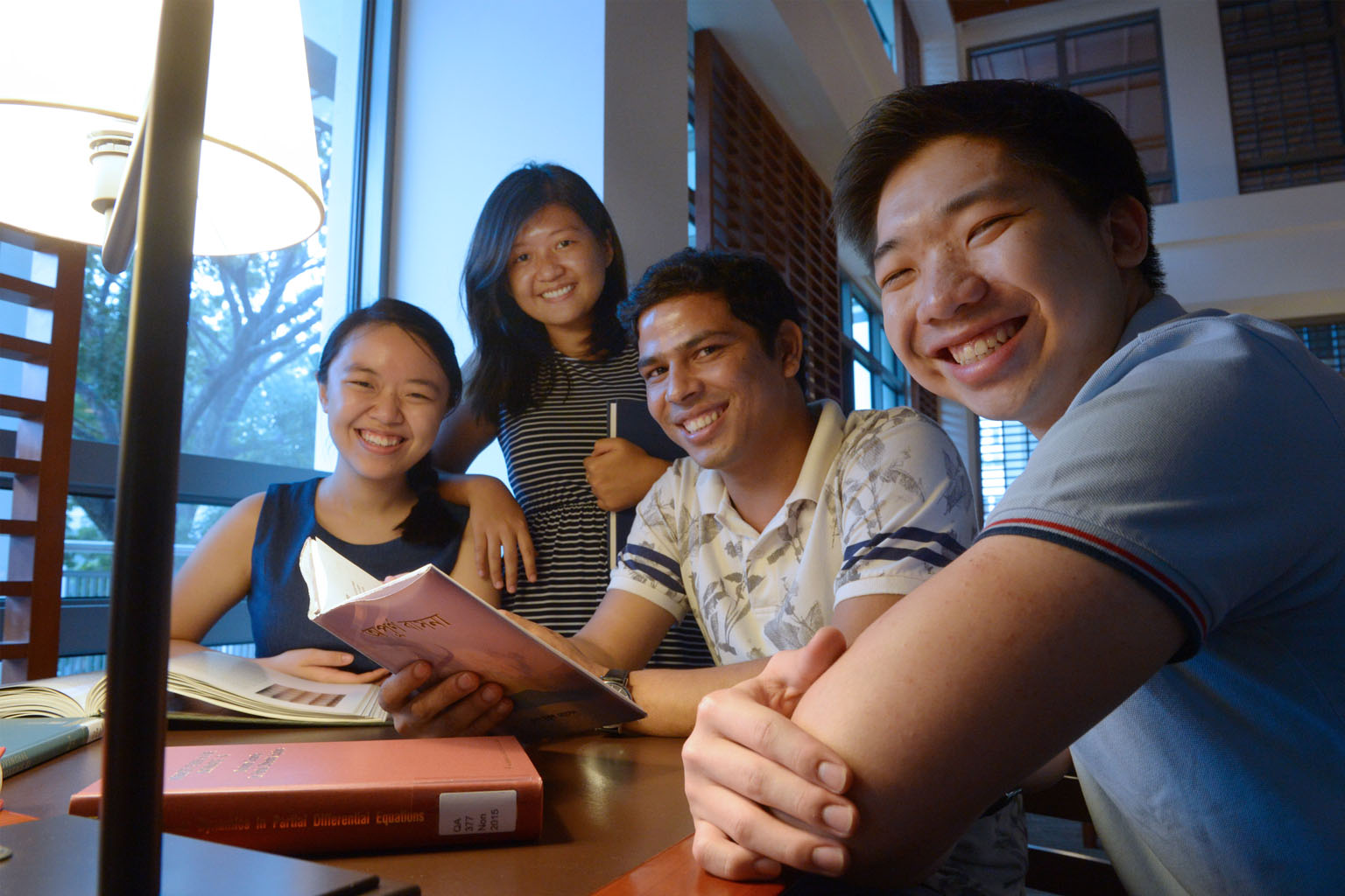 Bangladeshi worker Md Mukul Hossine (second from right) with students from the Migrant Workers Awareness Week organising committee, (from left) Ms Teo Xiao Ting, Ms Kimberley Pah and Mr Walter Yeo. Mr Mukul will read his poetry to students as part of