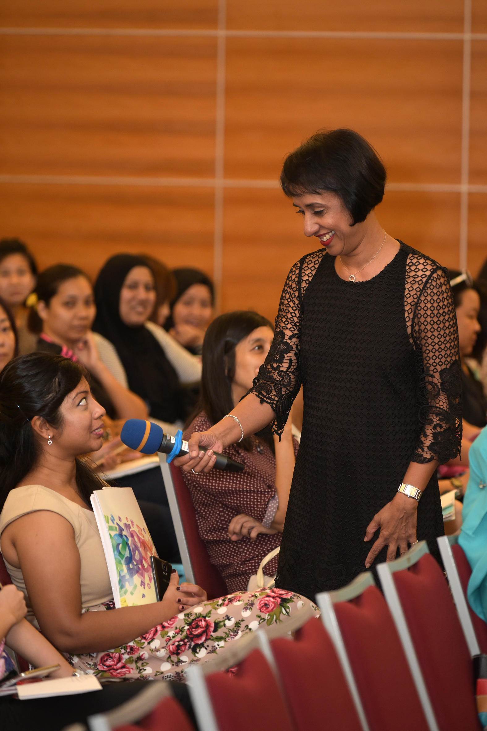 Ms Vasu interacting with a member of the audience during the teachers' briefing.