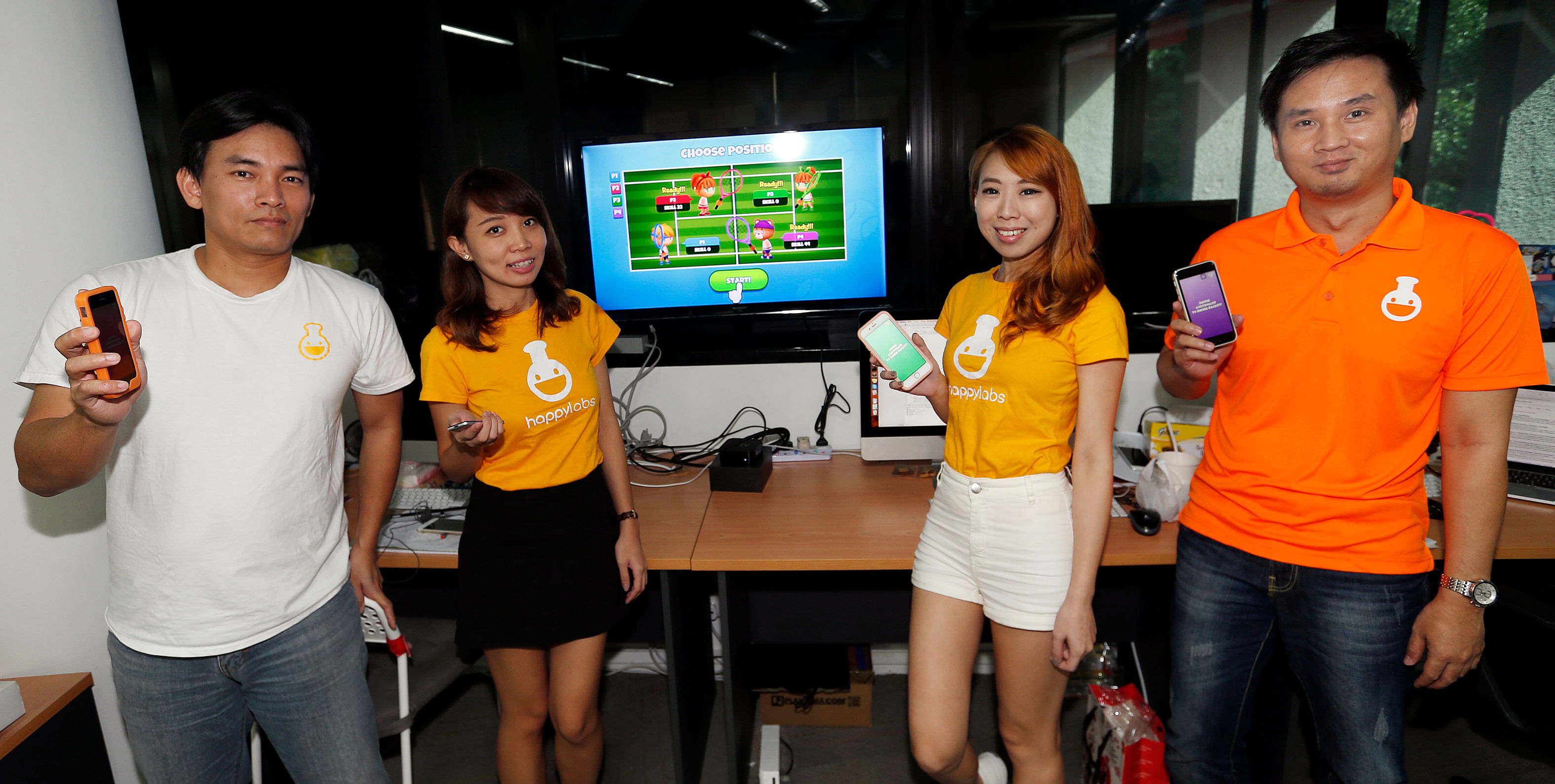 Local gaming company Happy Labs is one of the first in Asia to create a motion-sensing game for the Apple TV. Their app, Happy Tennis, allows players to use one Apple TV Remote and 3 iPhones to play virtual tennis. Seen here are (from far left): CEO 