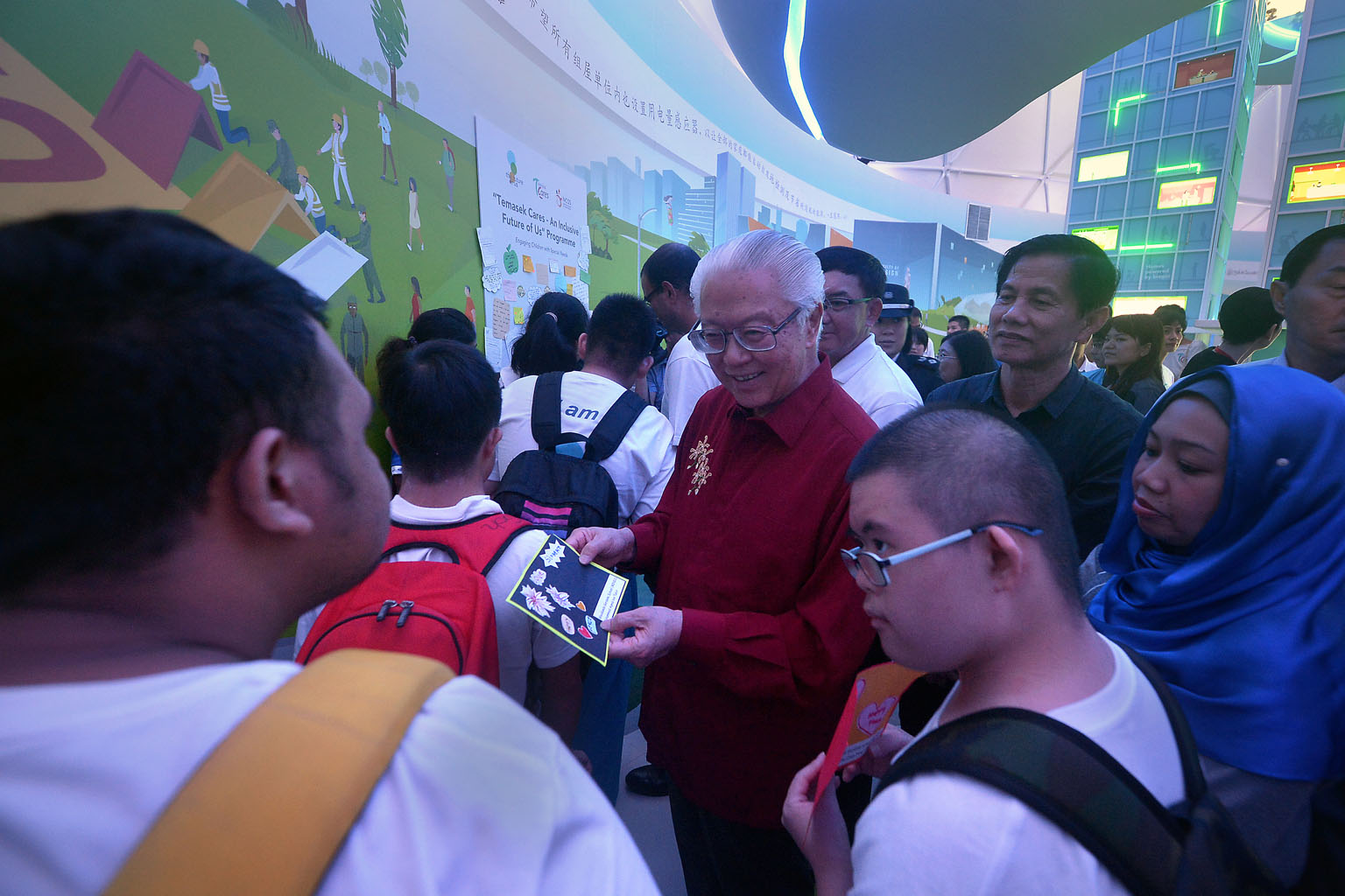President Tony Tan Keng Yam chatting with students with special needs at the Home Tomorrow dome at The Future Of Us exhibition yesterday. The outing was part of an outreach programme that will benefit over 6,000 children with special needs.