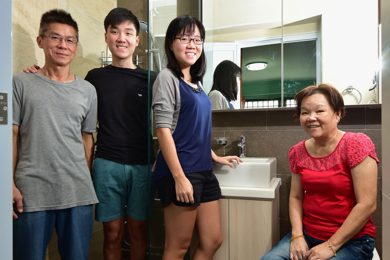Miss Jasmine See (third from left) with her dad Victor, brother Nicholas and mum Joyce in their renovated, "hotel-concept" bathroom.