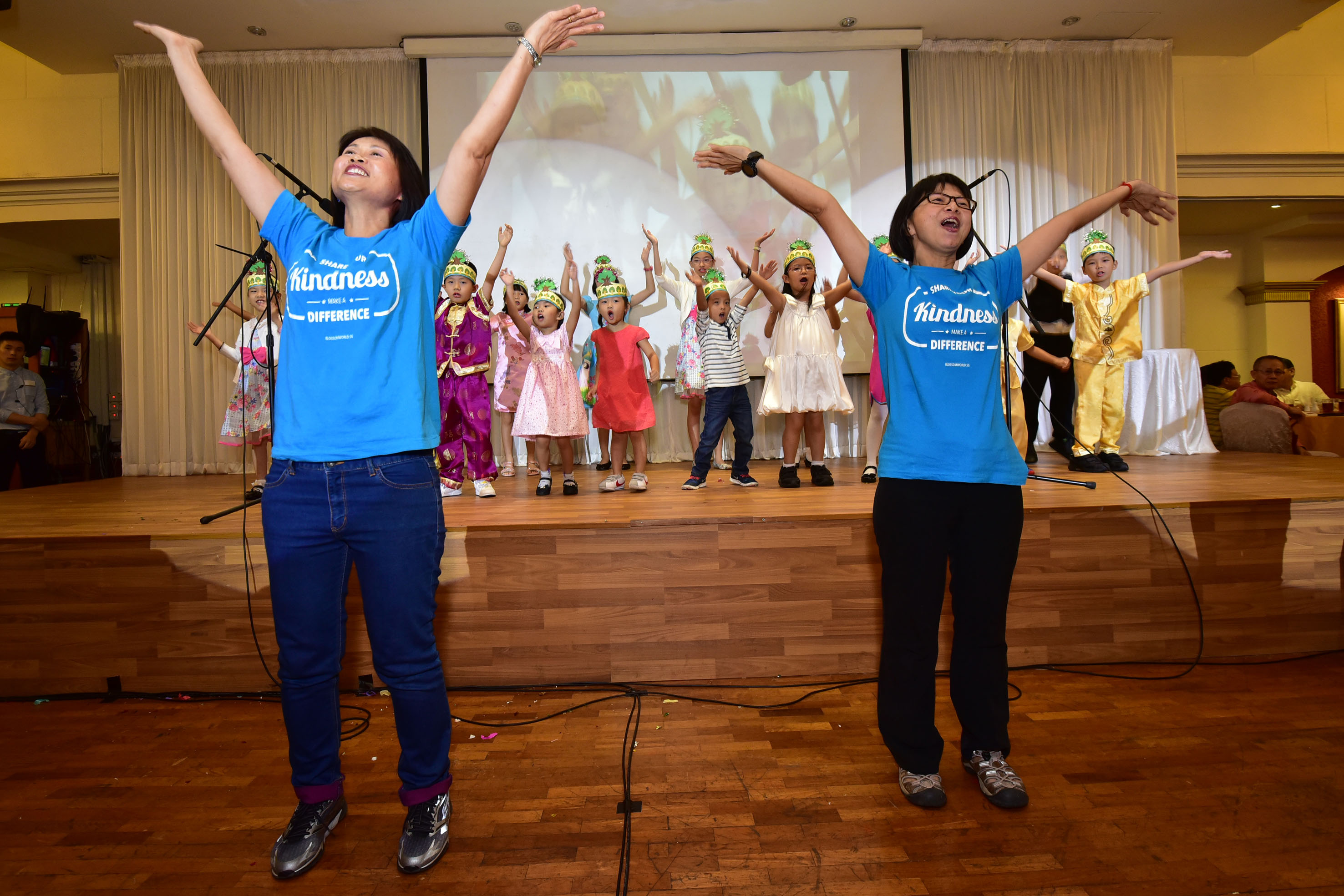 Ms Yeo Soo Cheng (far left) and Ms Anna Ong, both volunteers from Blossom World, performing with the Blossom Kids. More than 1,000 people celebrated Valentine's Day and the seventh day of the Chinese New Year ("Ren Ri" or the birthday of mankind) ove