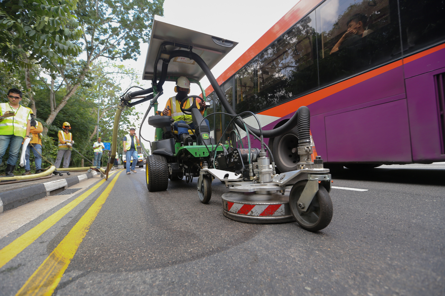 The fourth lane of Lornie Road towards Adam Road being cleaned up yesterday. The spill was caused by a mobile crane that had broken down and leaked hydraulic oil.