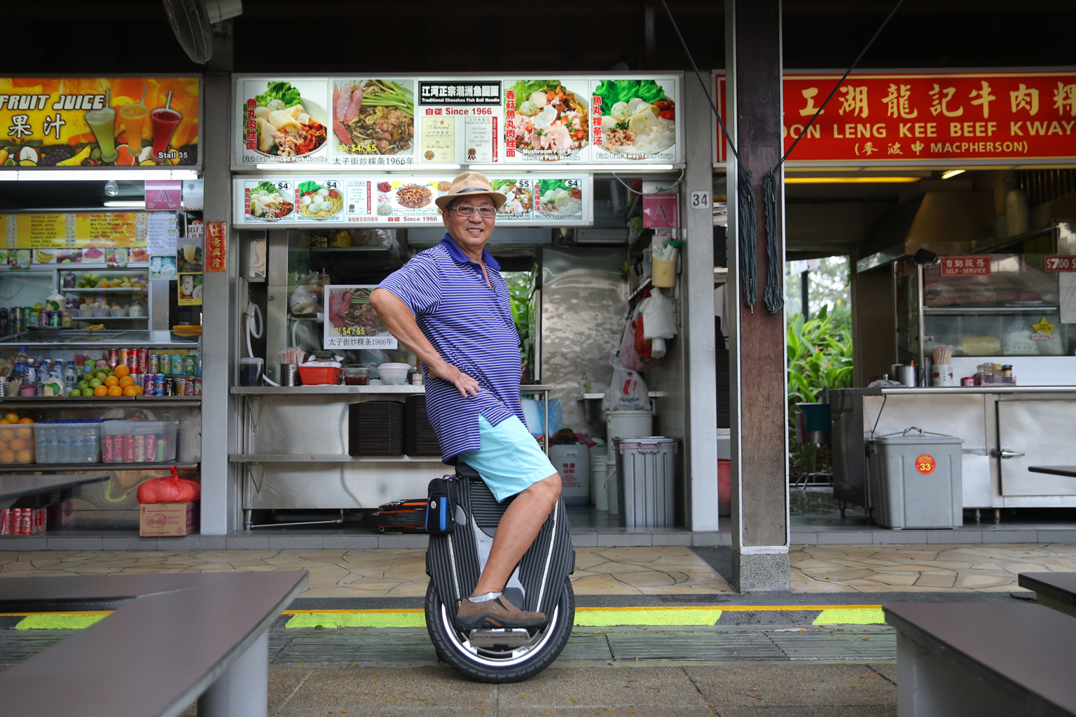 Mr Lim Teh Kea on his unicycle in front of his fishball noodle stall. He rides it to work and to the wet market. He says it cuts his 15-minute walk to work to a one-minute ride.