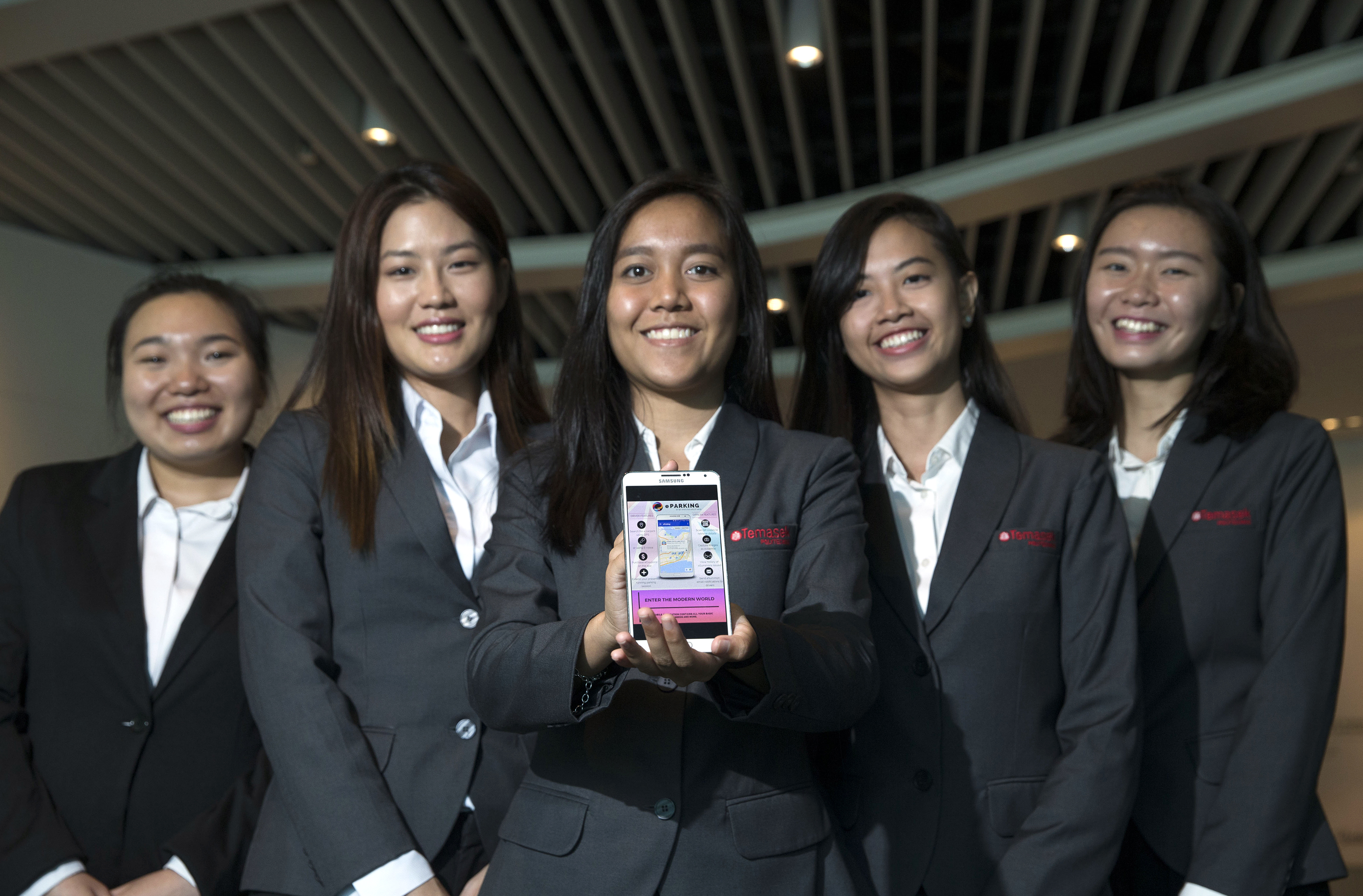 Temasek Polytechnic business information technology students (from left) Ye Xianmin, 20; Nittayawan Charoenkharungrueang, 22; Nur Raeesah Bte Abdul Mallik, 20; Nur Namirah Bte Anee, 20; and Jolene Tan, 19, with the eParking app they created. Their ap