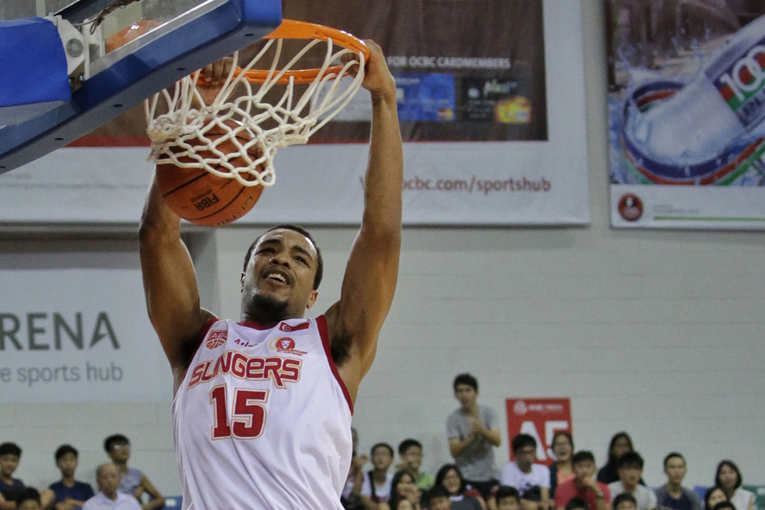 Singapore Slingers' Xavier Alexander dunking as Hi-Tech Bangkok City's Piyapong Piroon watches. Alexander was guilty of missing crucial free throws in the fourth quarter at the OCBC Arena yesterday.