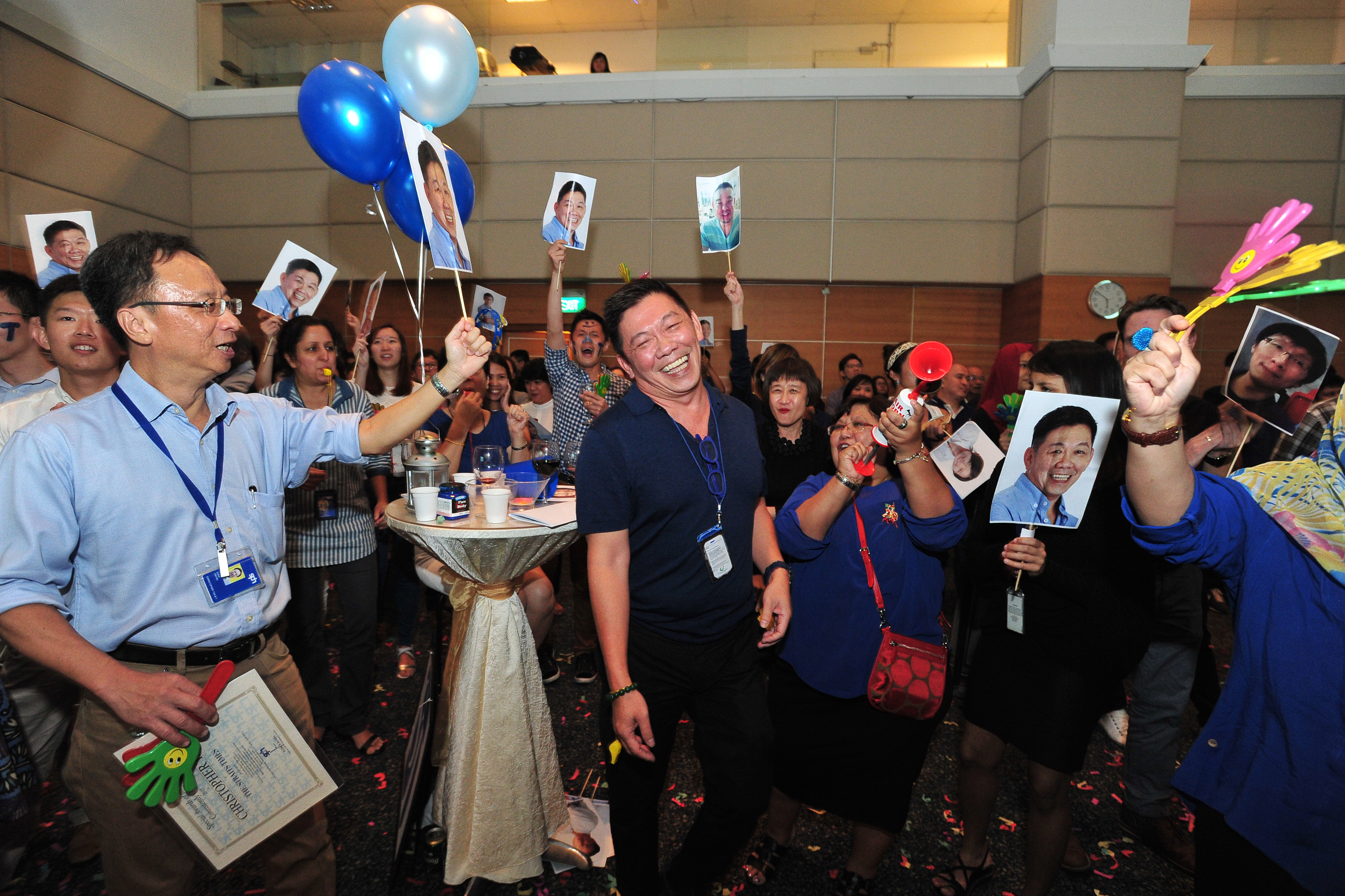 Journalist of the Year Wong Kim Hoh (centre) and senior transport correspondent Christopher Tan (left), who won a Special Award for Consistently Good Work, celebrating their wins with their colleagues from the newsroom yesterday. ST swept 12 out of 1