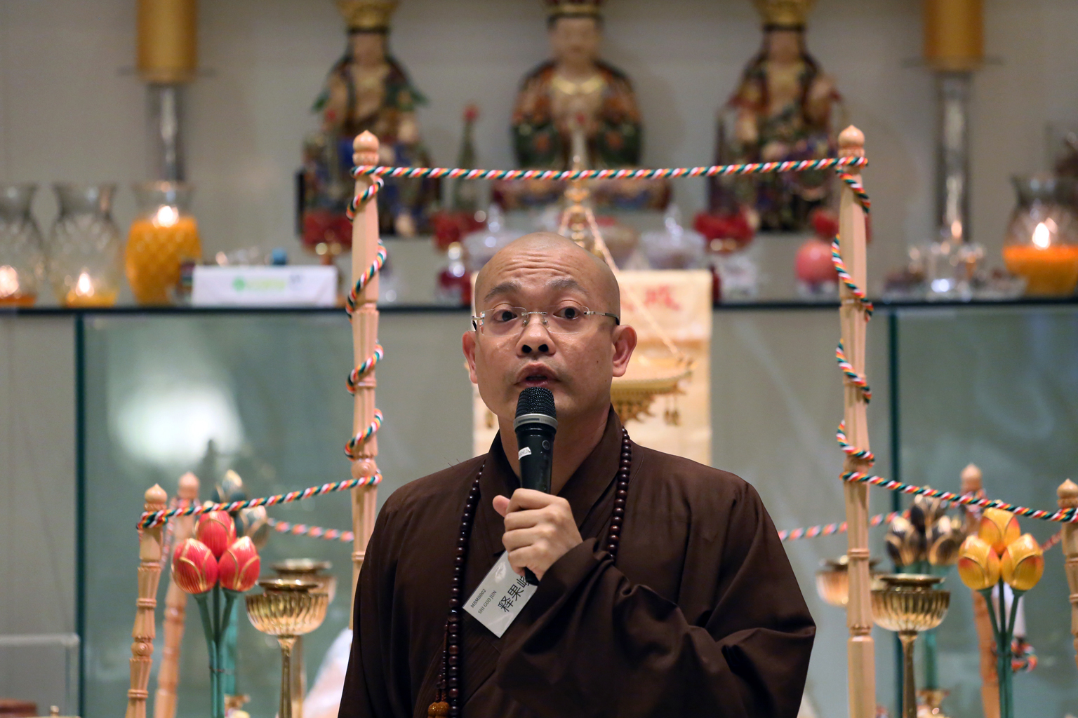 Ven Guojun has been criticised for owning a Sydney property, not wearing his monk's robes in public, and staying at a luxury hotel.