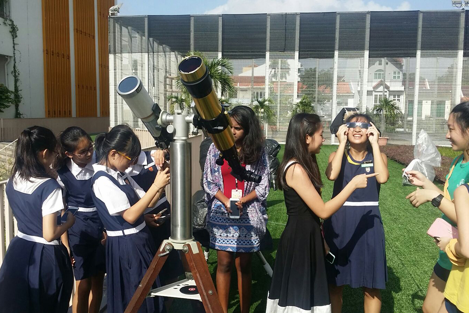 Students and teachers from Paya Lebar Methodist Girls' School (Secondary) participating in the solar observation programme. The students have been learning to observe the sun through the 11 solar telescopes set up in the school's sky garden since Feb