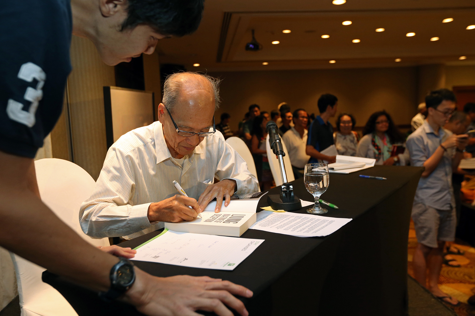 Dr Poh signing a copy of his book at the launch event on Feb 13.