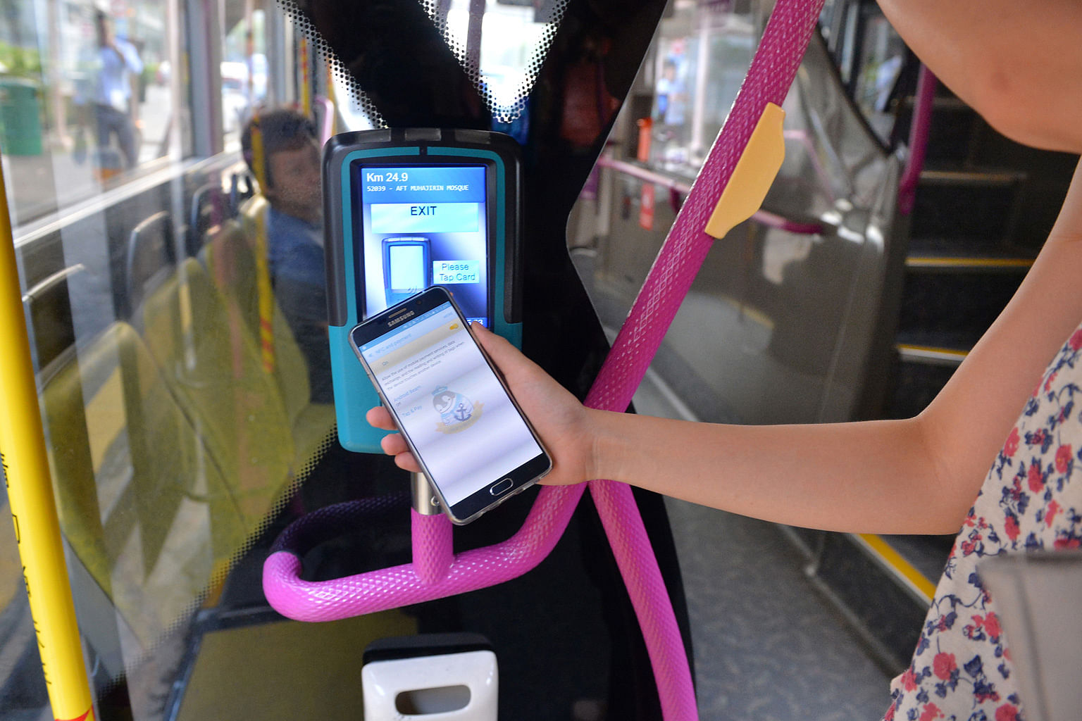 Even though NFC technology can now be used in mobile phones to tap for payment on buses and trains, there remain some snags, including the card reader's sensor being unable to detect the chip (left) unless the phone is very near the reader.