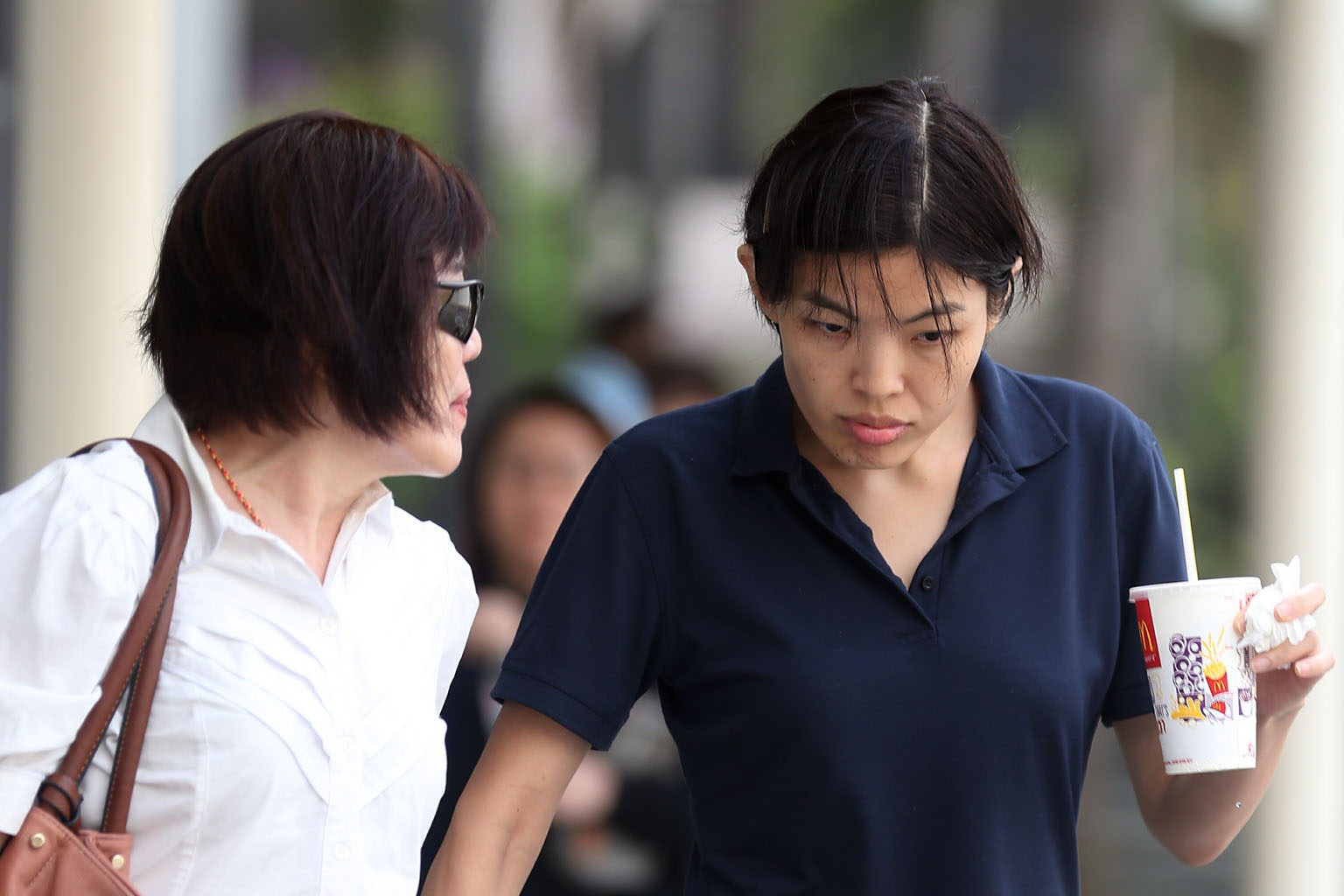 Low (right), who had pleaded guilty to five of 21 charges, appeared weak in court yesterday and was supported by her aunt.