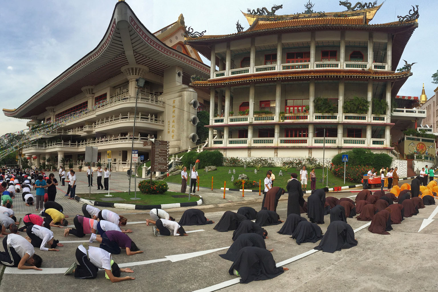 Buddhist monks leading devotees in the "three-steps, one-bow" procession along the perimeter of Kong Meng San Phor Kark See Monastery yesterday, the eve of Vesak Day. An estimated 15,000 devotees are expected to turn up throughout the night for the c