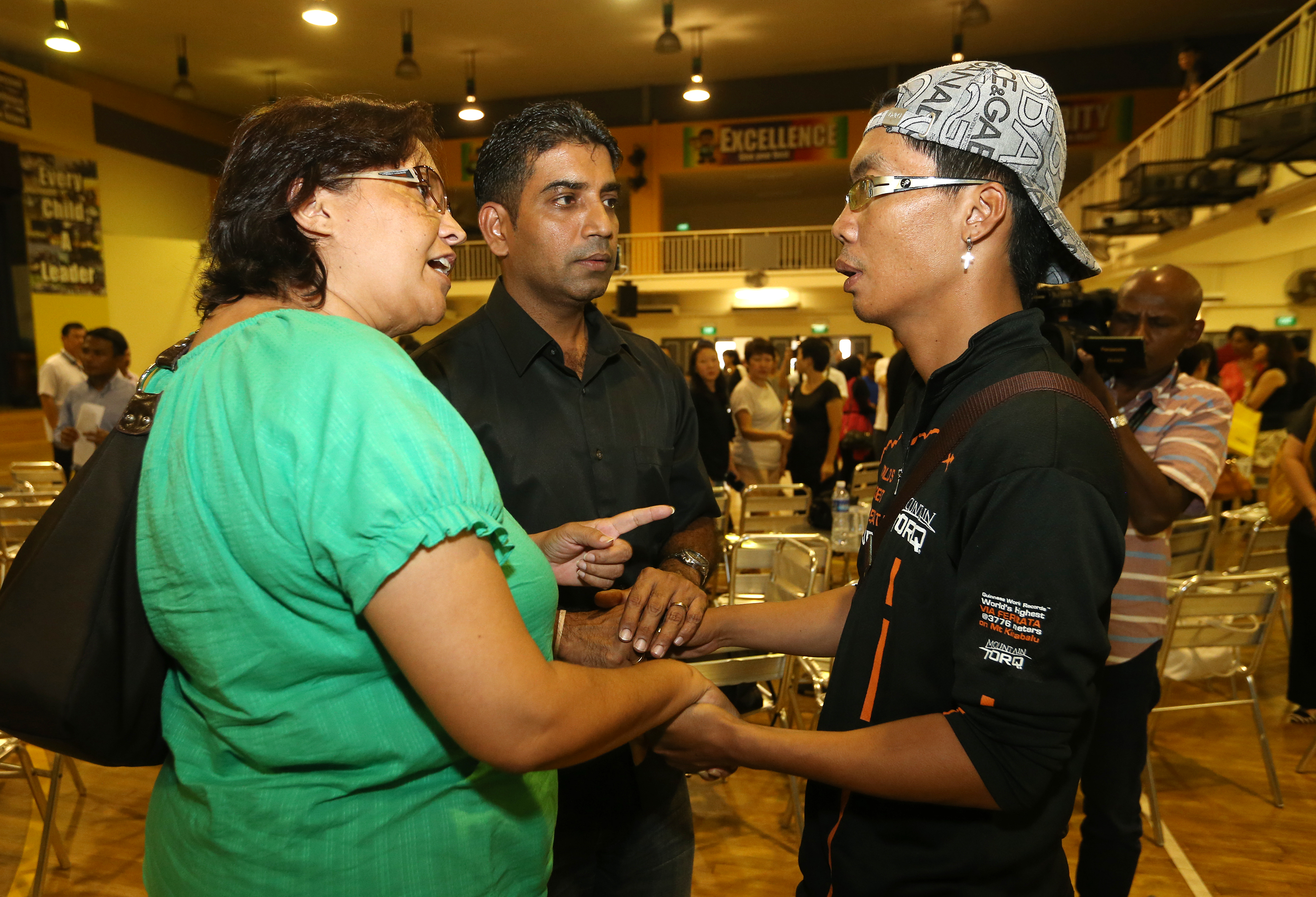 Trainer Hilary Hendry Augustinus (right) speaking with quake victim Sonia Jhala's parents Karen and Jaidipsinh at TKPS last year.