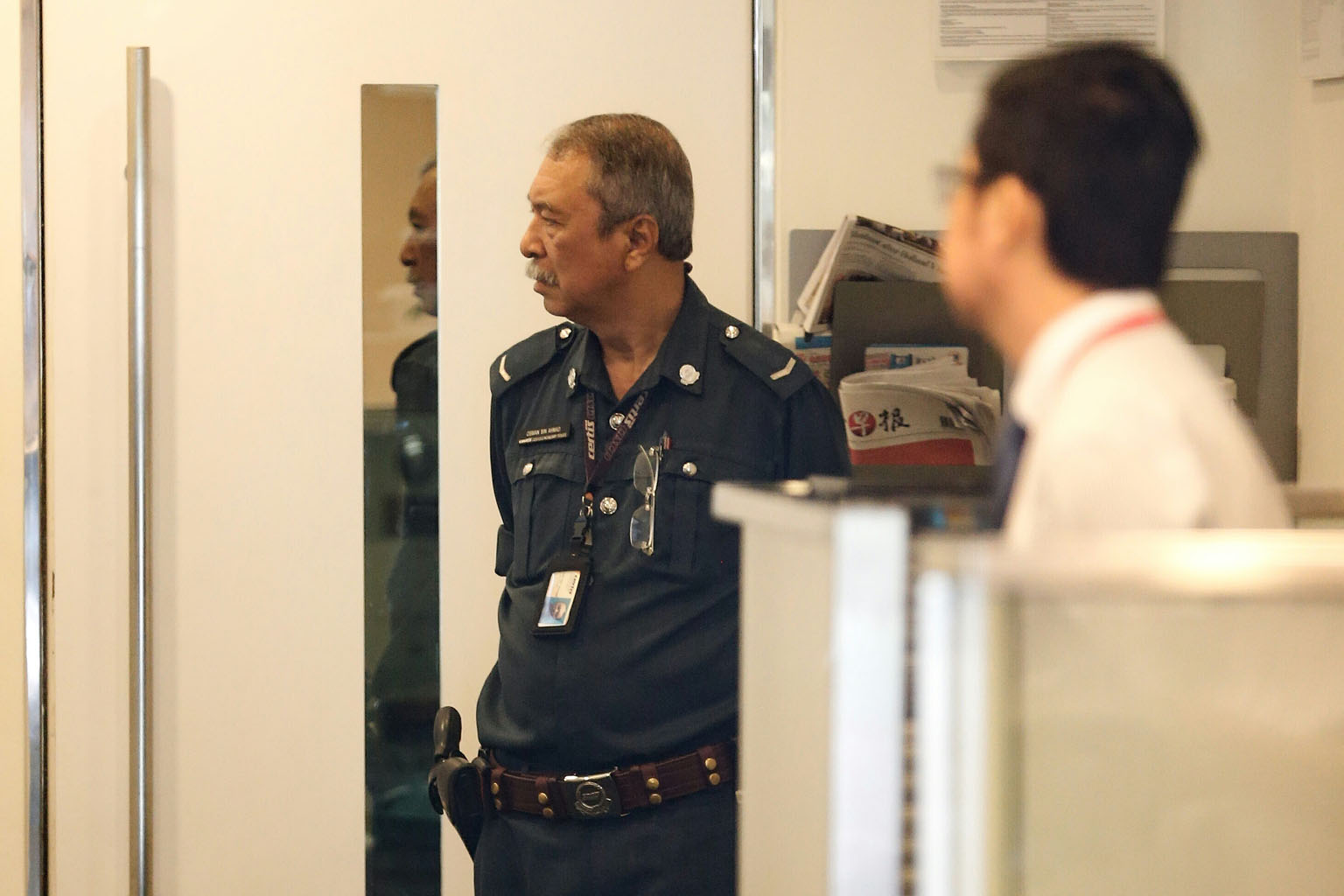 A Certis Cisco security guard at the StanChart branch in Holland Village yesterday, one day after a Caucasian man brazenly walked in around 11.25am, slipped the teller a piece of paper with his demands, then got away on foot with about $30,000 in cas