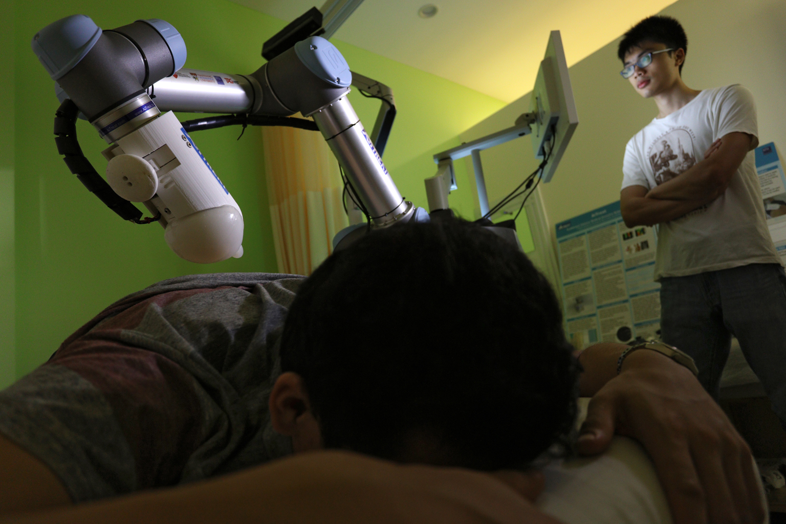 Emma, the robotic TCM massage therapist, demonstrating a massage at Kin Teck Tong yesterday. While the human therapist retains control of the treatment plan and consultation, Emma does the hard labour of kneading.