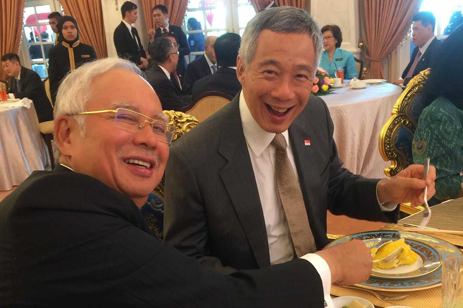 PM Lee and his wife Ho Ching with Mr Najib and his wife Rosmah Mansor, surrounded by the media at the Seri Perdana, the Malaysian Prime Minister's official residence, in Putrajaya yesterday. PM Lee and Mr Najib at yesterday's lunch hosted by the Mala