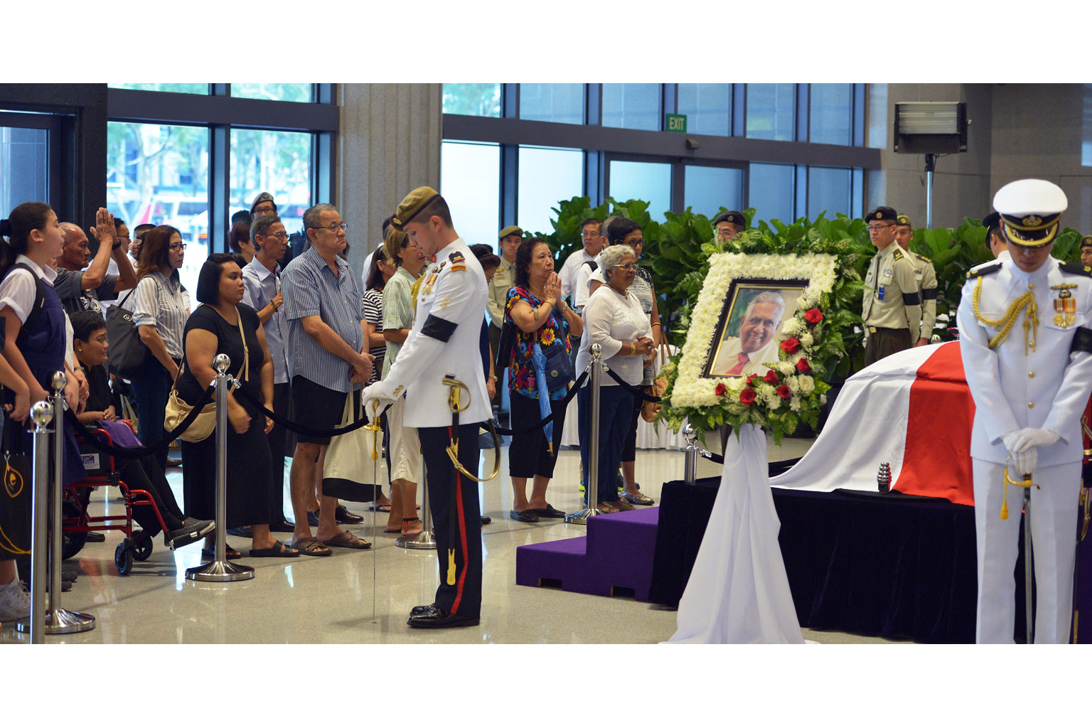 Outside City Hall MRT station, an elderly man played Auld Lang Syne on a harmonica. Members of the public paying their respects to Mr Nathan at Parliament House yesterday. People from all walks of life joined the queues at the Padang to wait for thei