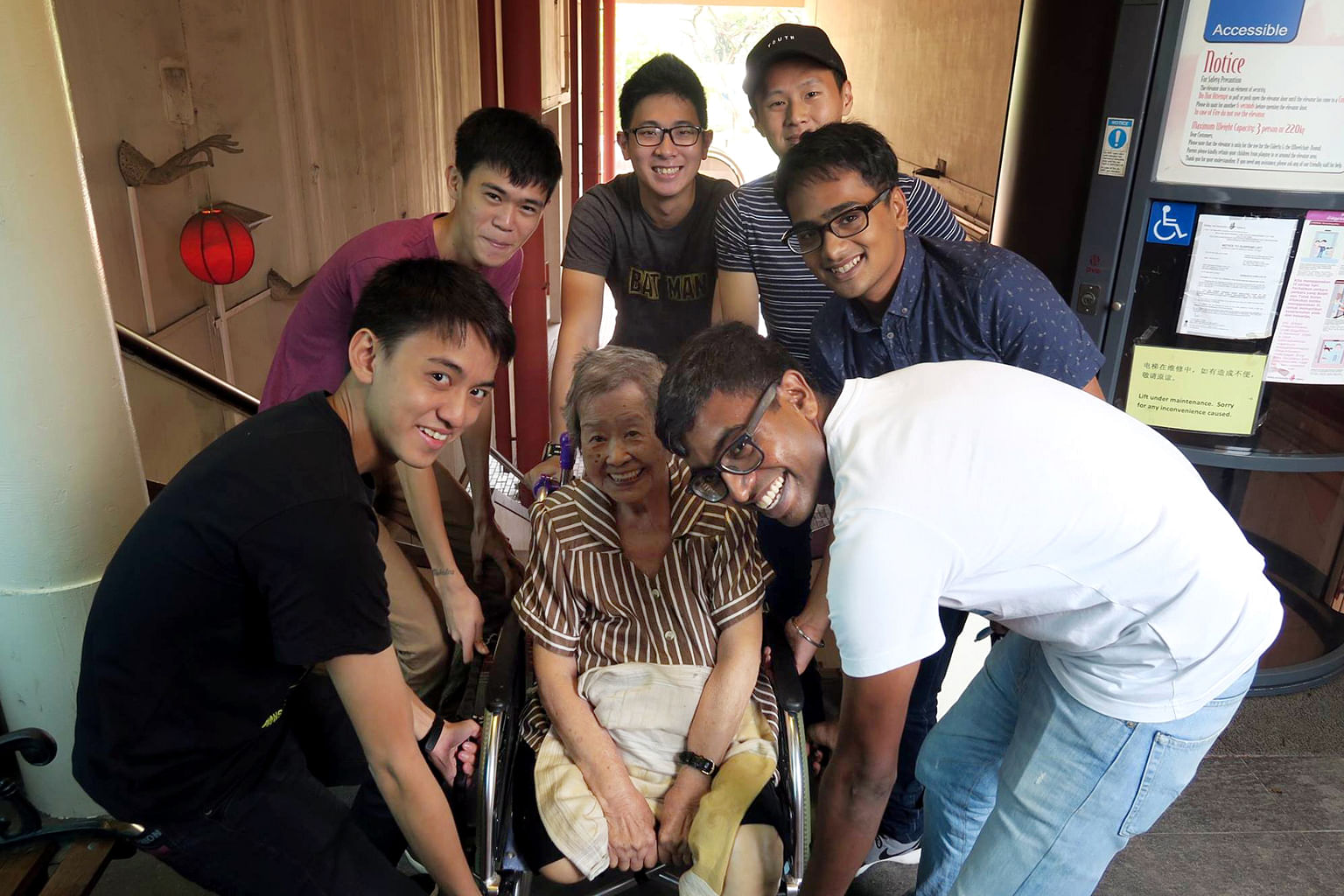Giving Madam Loh's mother-in-law a lift up the stairs to the restaurant are (from left) Lance Cpl Wong, Pte Ng, Pte Ko, Lance Cpl Teo, 3SG Singh and MSG Johan.
