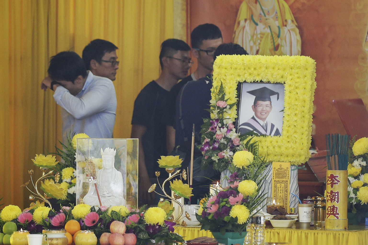 Friends of Mr Koh at his wake yesterday. The 30-year-old was in his kayak last Saturday when it hit driftwood and overturned in a river in Perak, Malaysia.