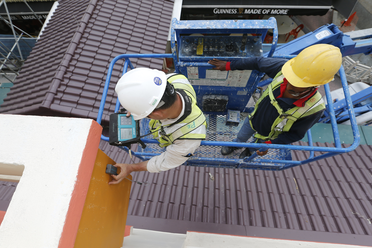 A tester using ultrasound scanning equipment to inspect a sunshade at the Tampines block where another sunshade was partially dislodged in September. Mr Wong said his ministry will review its policies and benchmark them against those of other high-ri