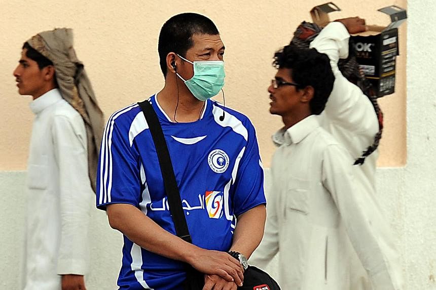 A foreign worker living in Riyadh wears a mask covering his mouth and nose on a main street in the Saudi capital on April 29, 2014 as the death toll from the newly emerged and often fatal Middle East Respiratory Syndrome (MERS) disease topped 100 in 