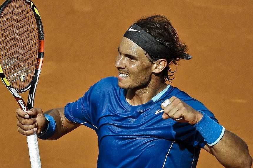 Rafael Nadal of Spain celebrates winning against Roberto Bautista Agut of Spain in their semi-final match for the Mutua Open Madrid Masters 1000 tennis tournament in Madrid, Spain, on May 10, 2014. -- PHOTO: EPA
