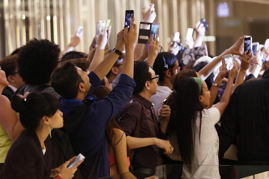More than 100 well-heeled women jostled for a chance to snap a picture of themselves with British celebrity designer Victoria Beckham, better known as Posh Spice, at a private event on the evening of May 12, 2014. &nbsp;-- PHOTO: DESMOND LUI