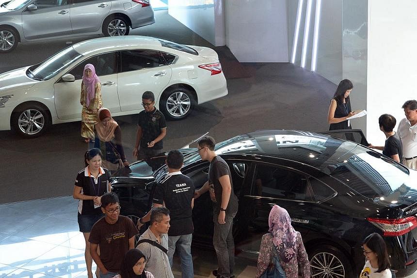 Potential buyers at the Nissan showroom in Ubi Road on Saturday, after the unexpected fall in COE premiums last week.