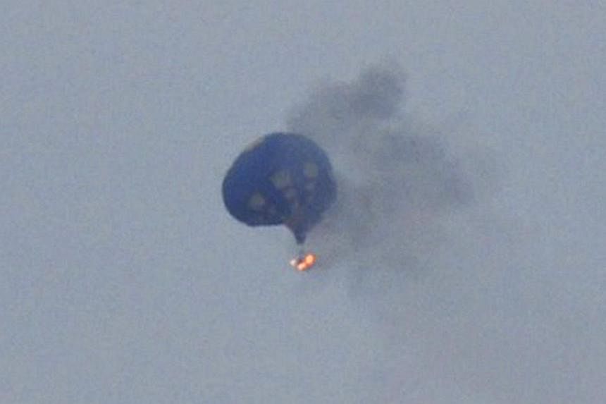 Witnesses watched in horror last Friday as the balloon caught fire in the evening sky after hitting a power line as it was coming down into a pre-designated field near the state capital Richmond. -- FILE PHOTO: REUTERS/LYNN SHULTZ