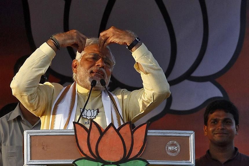 Hindu nationalist Narendra Modi (front left), the prime ministerial candidate for India's main opposition Bharatiya Janata Party (BJP), gestures as he addresses an election campaign rally in Barasat, north of Kolkata on May 7, 2014. India's oppositio