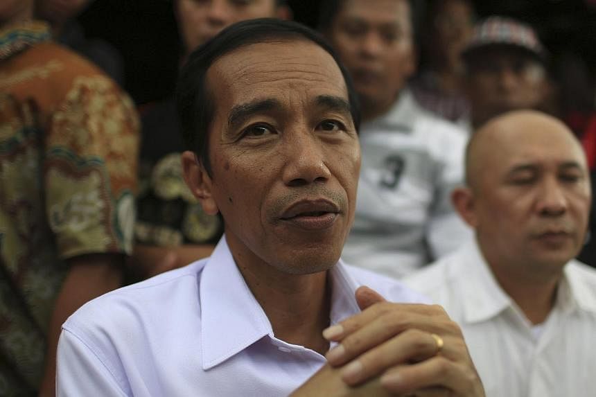 Indonesian presidential frontrunner Joko "Jokowi" Widodo's plan to slowly reduce fuel subsidies over the next few years is the best option to ease pressure on the budget deficit while keeping inflation in check, economists said. -- FILE PHOTO: REUTER