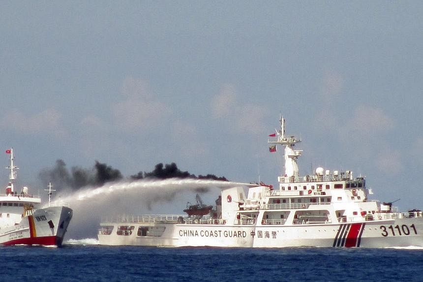 &nbsp;A Chinese ship (right) uses water cannon on a Vietnamese Sea Guard ship on the South China Sea near the Paracels islands, in this handout photo taken on May 3, 2014 and released by the Vietnamese Marine Guard on May 8, 2014.&nbsp;China's milita