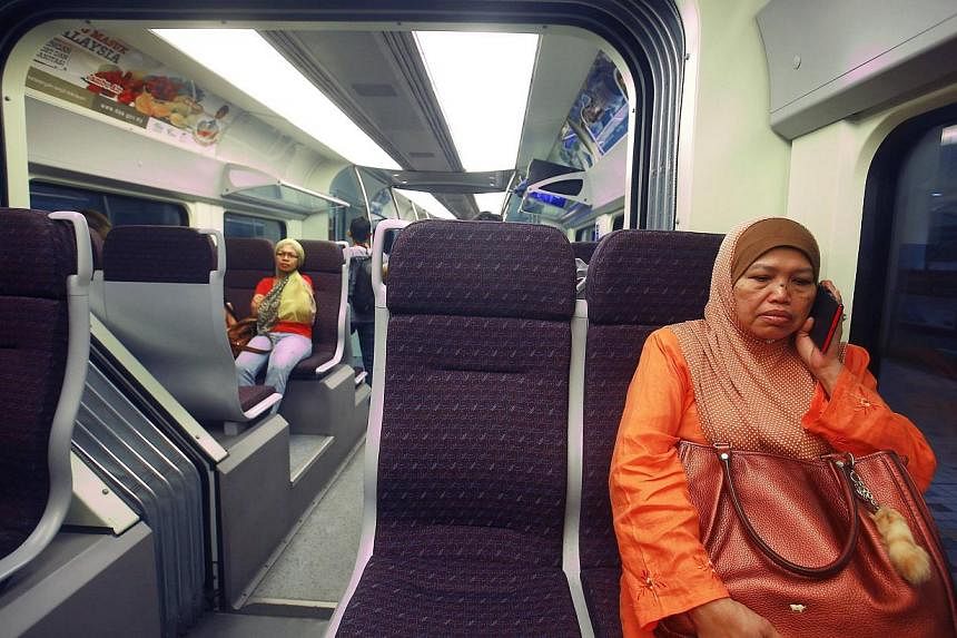 A woman sits inside the new Express Rail Link train enroute from KL Sentral to KLIA2 airport. Malaysia's Land Public Transport Commission plans to complete Phase 2A of the High-Speed Rail System connecting Kuala Lumpur and Singapore this year. -- FIL