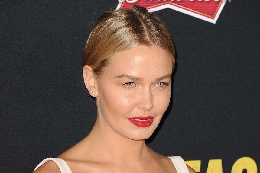 Lara Bingle, the model girlfriend of Australian Hollywood star Sam Worthington, was handed a suspended jail sentence on Tuesday for driving offences and was warned she is not above the law. -- PHOTO: AFP