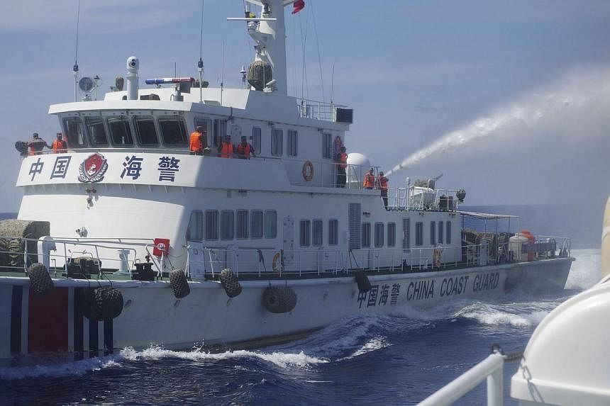 A Chinese ship (left) uses water cannon on a Vietnamese Sea Guard ship on the South China Sea near the Paracels islands, in this handout photo taken on May 2, 2014, released by the Vietnamese Marine Guard on May 8, 2014.&nbsp;China's foreign ministry