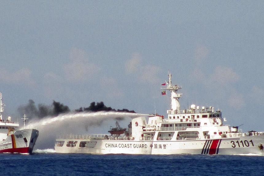 A Chinese ship (right) firing water cannon at a Vietnamese Sea Guard ship on the South China Sea, in this handout photo taken on May 3 and released by the Vietnamese Marine Guard on May 8. Such confrontations are contrary to China's promises of restr