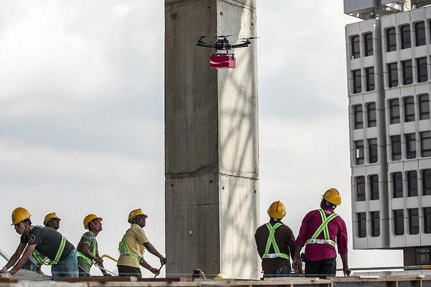 A drone delivering cans of Coca-Cola to construction workers at a high-rise work site. The cans carried handwritten notes from Singaporeans thanking the foreign workers for their labour.