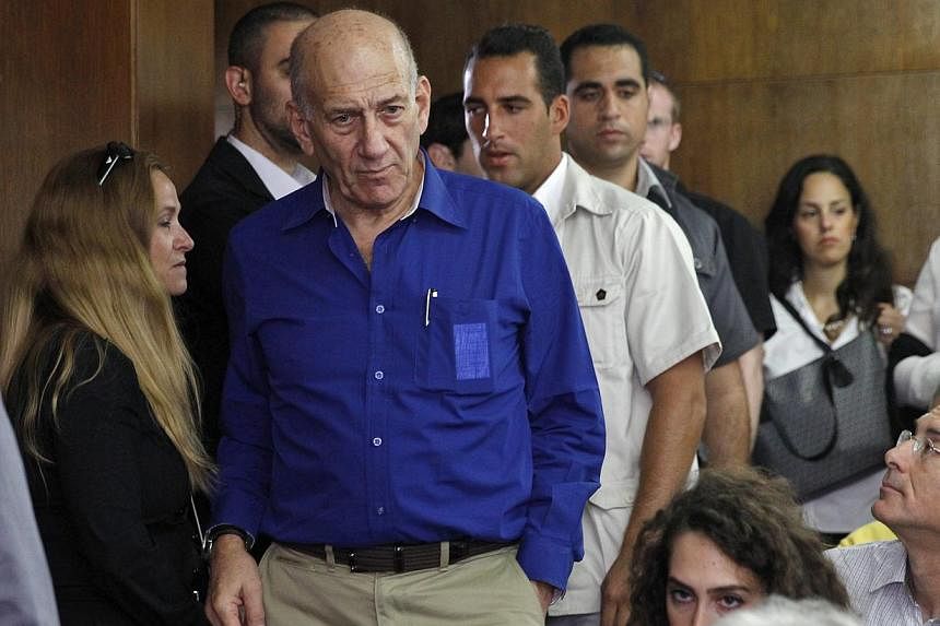 Former Israeli Prime Minister Ehud Olmert (centre) arrives at the Tel Aviv District Court, in Tel Aviv, Israel, on May 13, 2014. Ehud Olmert was once described as "probably the best" politician Israel had ever produced, but a major graft scandal has 