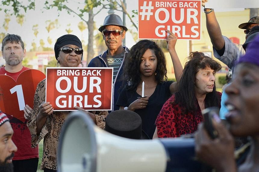 People participate in a Bring Back Our Girls campaign demonstration and candlelight vigil, held on Mother's Day in Los Angeles on May 11, 2014.&nbsp;Manned US aircraft were in the skies above Nigeria on Tuesday in the hunt for more than 200 missing s