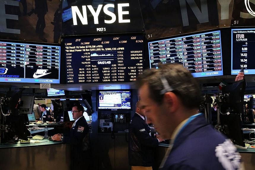 Traders work on the floor of the New York Stock Exchange on May 13, 2014 in New York City. -- PHOTO: AFP