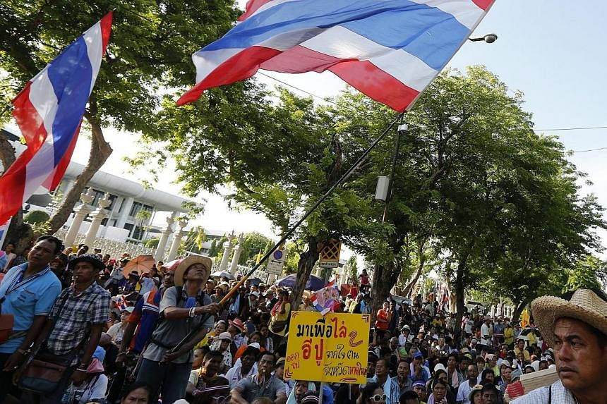 Thai anti-government protesters gather in front of the Parliament, as the senators meet inside, in Bangkok, Thailand on May 12 2014. Thailand's interim prime minister will meet the Election Commission (EC) on Wednesday, in the hope of fixing a date f