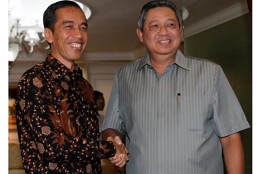Jakarta Governor Joko 'Jokowi' Widodo (left) an Indonesian presidential candidate nominated by the opposition Indonesian Democratic Party of Struggle, poses with Indonesian President Susilo Bambang Yudhoyono (right) during their meeting in Jakarta, I